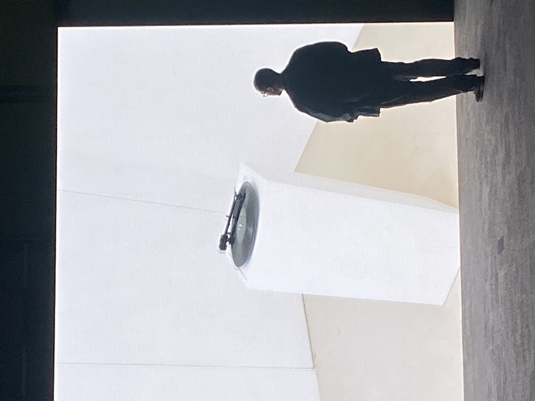 Tobias Endres standing in front of a bright installation with a turntable.
